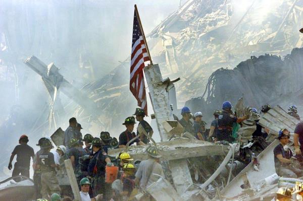 An American flag is posted in the rubble of the World Trade Centers.